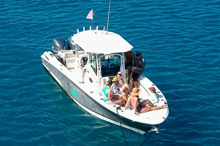 Guests relaxing on bow of Seas the Day Charters USVI M/V Aquarius moored on St. John