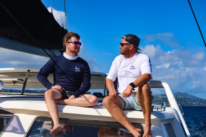 Seas the Day USVI Captain Jason and First Mate Henry in conversation aboard S/Y Leviathan, a 50-foot private catamaran charter boat departing from St. Thomas in the US Virgin Islands