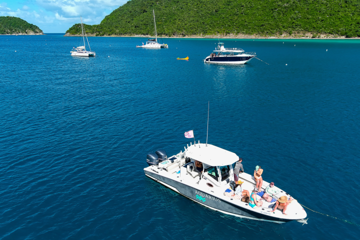 Guests relaxing on bow of Seas the Day Charters USVI M/V Aquarius moored on St. John