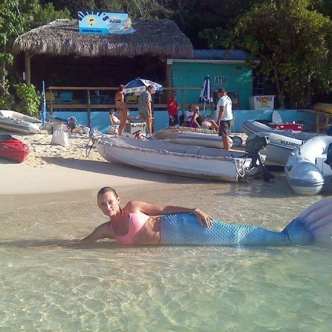 a group of people sitting in a swimming pool