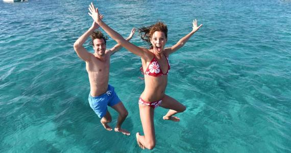 2 Seas the Day Charters USVI guests jumping into the water from their private charter boat