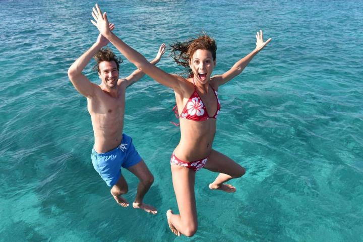 2 Seas the Day Charters USVI guests jumping into the water from their private charter boat