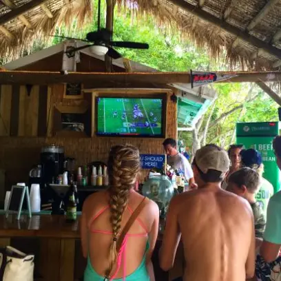 a group of people standing around a table