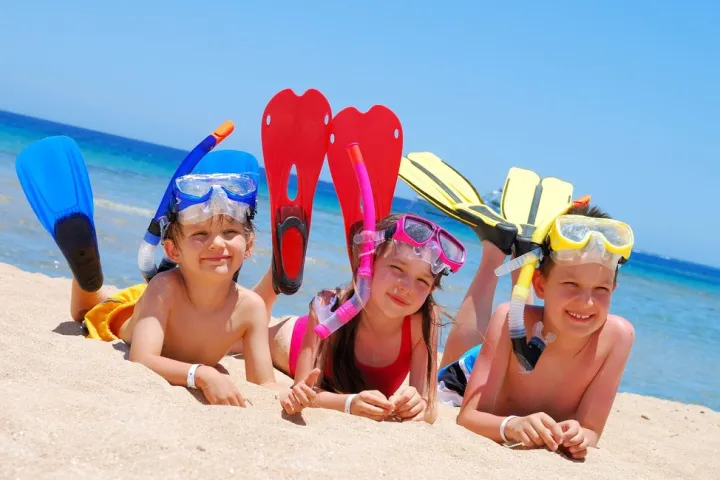a group of people sitting at a beach