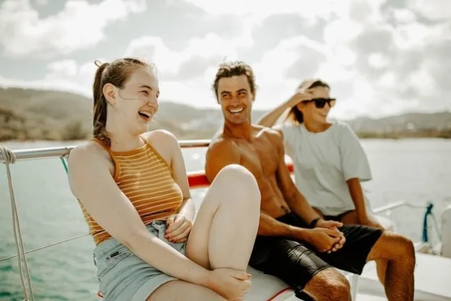Aiden Turner and woman sitting next to a body of water