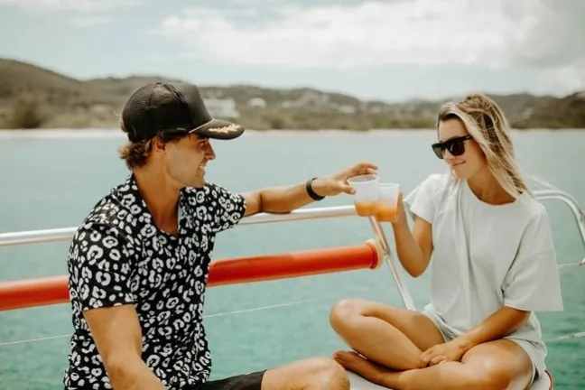a woman standing next to a body of water