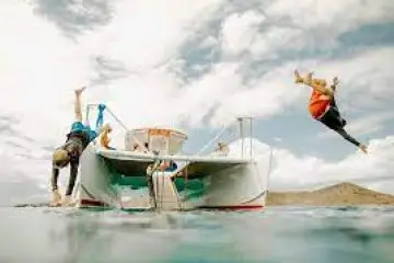 a group of people on a boat in the water