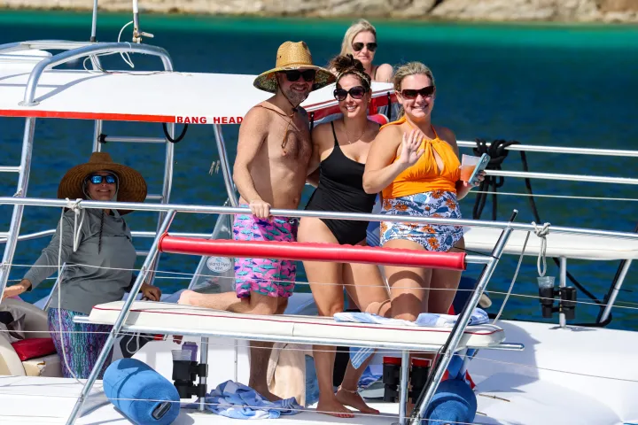4 Seas the Day Charters USVI guests posed for a photo on M/V Island Flyer with Captain Hilary at the helm