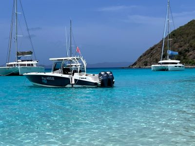 Seas the Day Charters USVI powerboat M/V Aquarius anchored near two other charter boats at Jost Van Dyke, British Virgin Islands