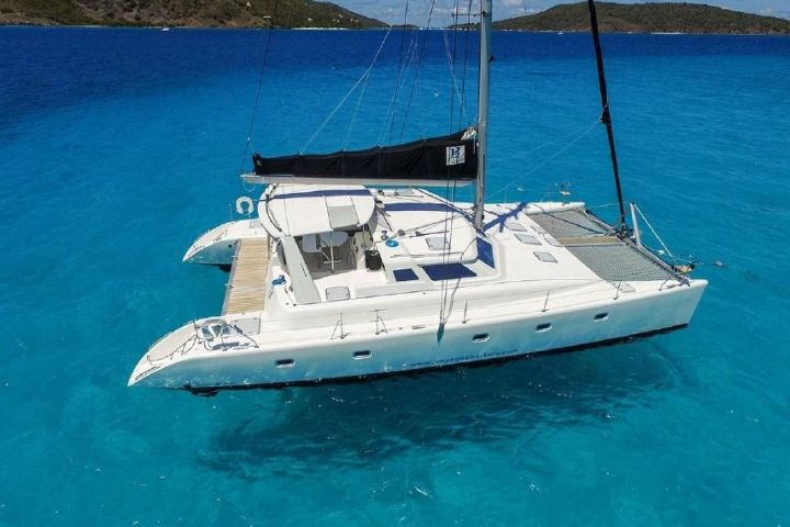 a blue and white boat floating on a body of water