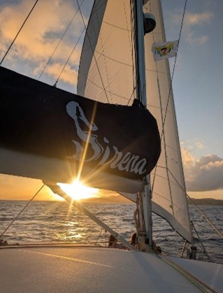a sunset behind a boat